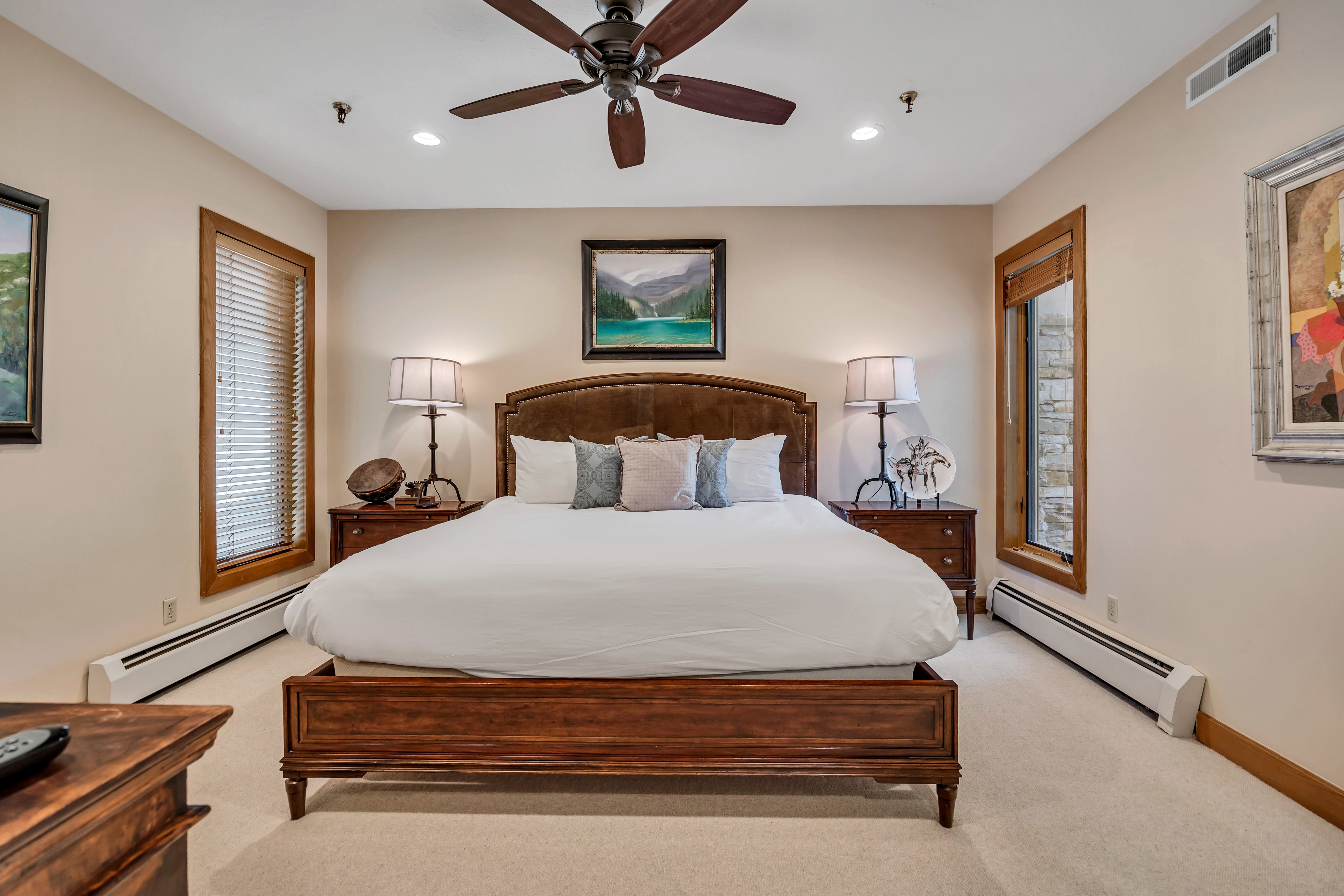 Bedroom featuring baseboard heating, light carpet, recessed lighting, and a ceiling fan