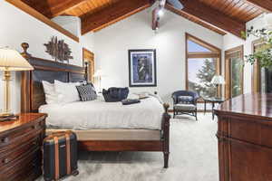 Bedroom with wood ceiling and carpet