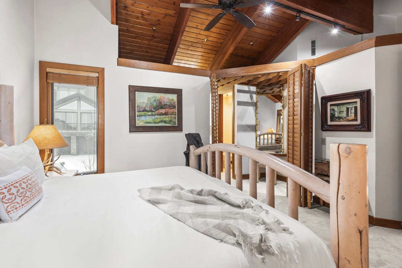 Bedroom featuring wooden ceiling and carpet floors