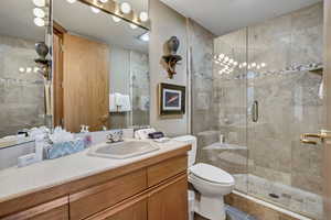 Full bath with vanity, a stall shower, and tile patterned floors