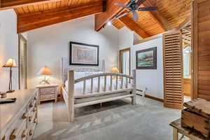 Bedroom with light colored carpet, wood ceiling, and baseboard heating