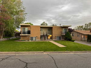 Rear view of house featuring brick siding and stairway