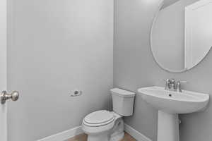 Bathroom with toilet and baseboards