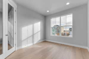 Spare room featuring light wood-style floors and recessed lighting
