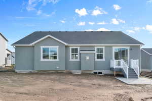 Rear view of house featuring roof with shingles and stucco siding