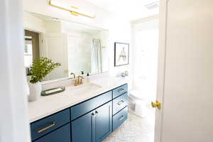 Bathroom with vanity and curtained shower