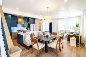 Dining space with light wood-type flooring and recessed lighting