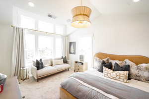 Bedroom with carpet floors, vaulted ceiling, and recessed lighting