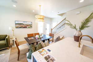 Dining space featuring stairs, light wood-style flooring, and recessed lighting