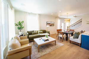 Living area with light wood-style flooring and recessed lighting