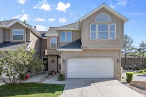 View of front of property with stucco siding, roof with shingles, a garage, and driveway