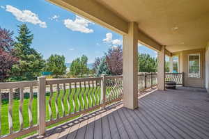Wooden terrace featuring a lawn