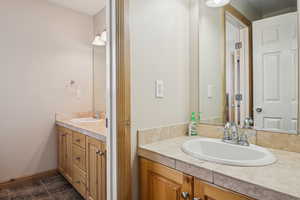 Bathroom featuring vanity and baseboards