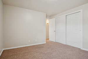 Unfurnished bedroom with carpet floors and a closet