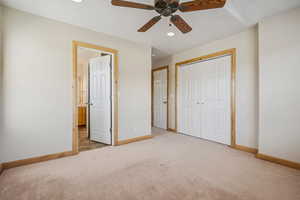 Unfurnished bedroom featuring carpet flooring, a closet, recessed lighting, ensuite bathroom, and a ceiling fan