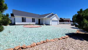 Ranch-style house with a garage and driveway