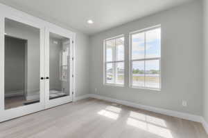 Spare room featuring light wood-type flooring and recessed lighting