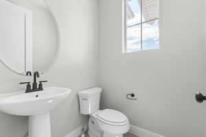 Bathroom with toilet and baseboards