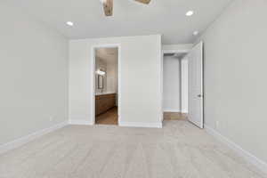 Unfurnished bedroom with carpet flooring, recessed lighting, ensuite bathroom, and ceiling fan