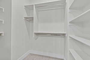 Walk in closet with carpet floors