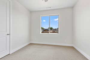 Unfurnished room with light carpet and a ceiling fan