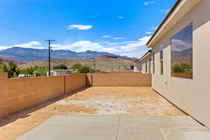 Fenced backyard with a patio and a mountain view