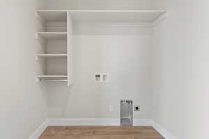 Laundry area featuring hookup for a washing machine, electric dryer hookup, and wood finished floors