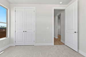 Unfurnished bedroom with carpet floors and a closet