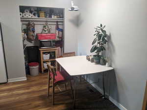 Dining area featuring baseboards and wood finished floors