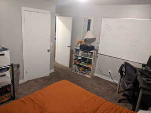 Carpeted bedroom with an office area