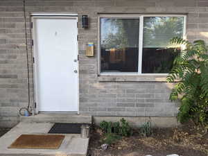 Entrance to property with concrete block siding