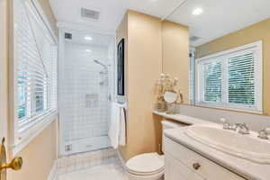 Full bath with vanity, a stall shower, and light tile patterned floors