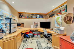 Office area with built in desk and recessed lighting