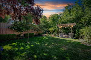 View of yard with a pergola, a patio area, and an outdoor hangout area