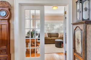 Entryway featuring hardwood / wood-style floors and crown molding