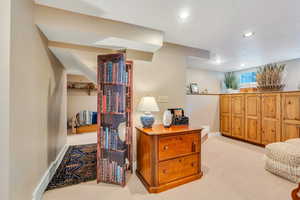 Living area featuring light carpet and recessed lighting