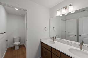 Bathroom featuring wood finished floors and double vanity
