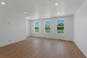 Spare room featuring light wood finished floors and recessed lighting