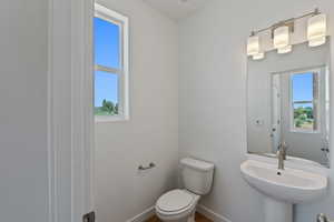 Bathroom with toilet and baseboards