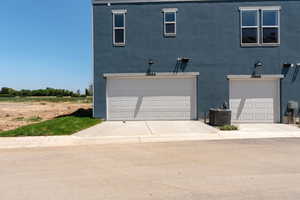 Traditional-style home featuring stucco siding, a garage, and concrete driveway