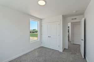 Unfurnished bedroom with carpet and a closet
