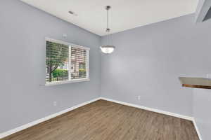 Empty room with wood finished floors and baseboards