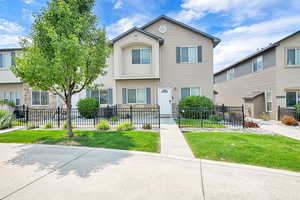 Multi unit property featuring a fenced front yard