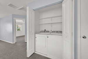 Laundry room featuring separate washer and dryer and carpet floors