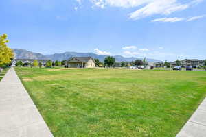 View of community featuring a mountain view, a residential view, and a yard