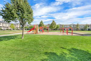 Community playground with a residential view and a lawn
