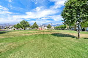 View of community with a mountain view and a yard