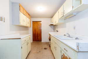 Laundry area with a sink