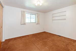 Unfurnished bedroom featuring carpet floors and a closet