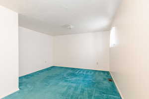 Carpeted empty room with baseboards